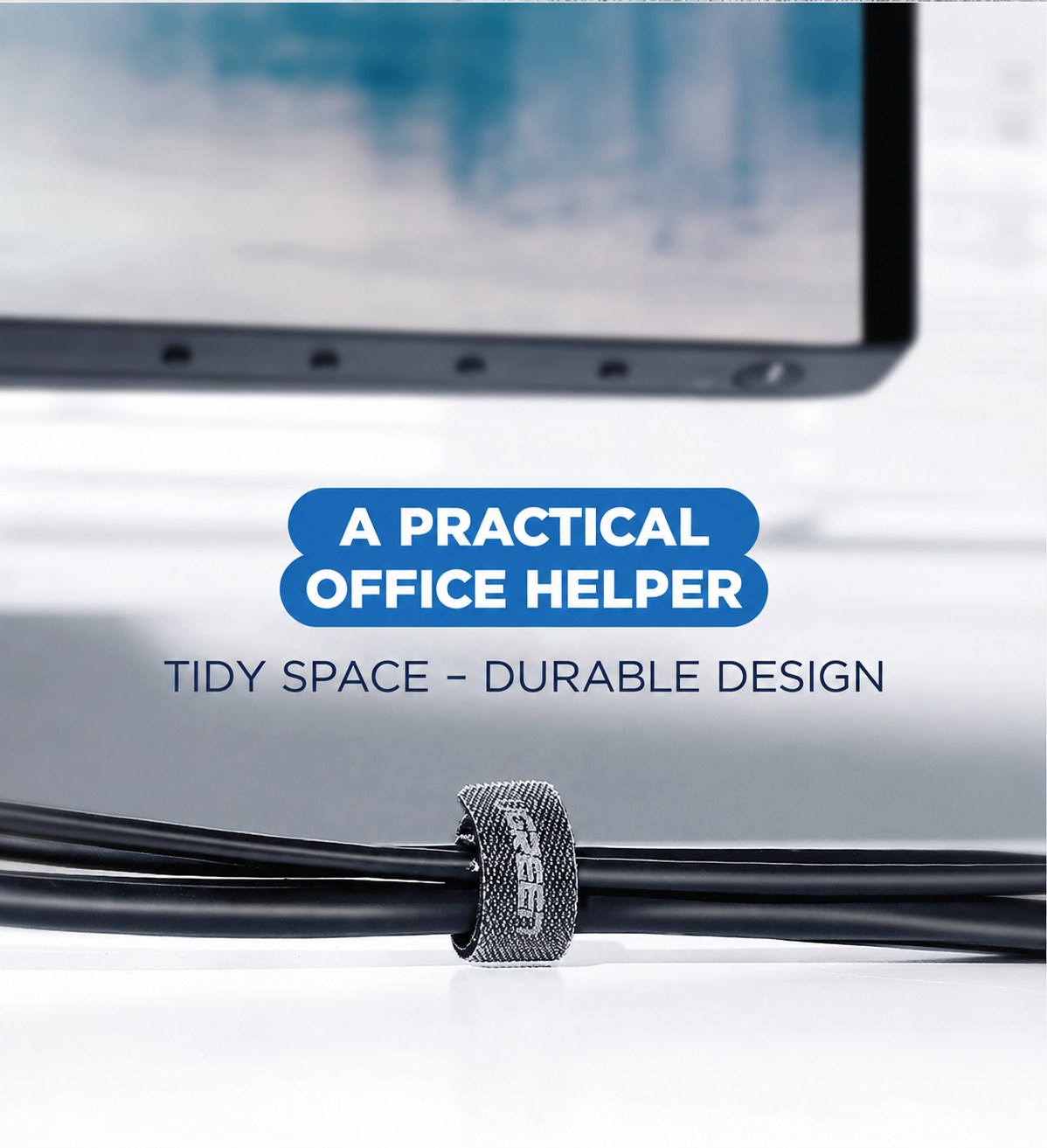 UGREEN 50370 black reusable cable tie organising a cable bundle beside a laptop