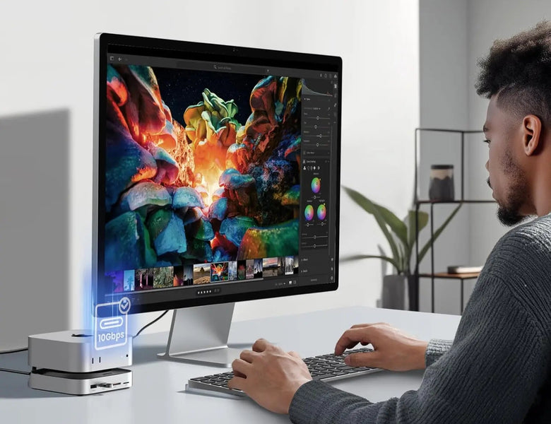 Person working at a desk setup with a UGREEN dock