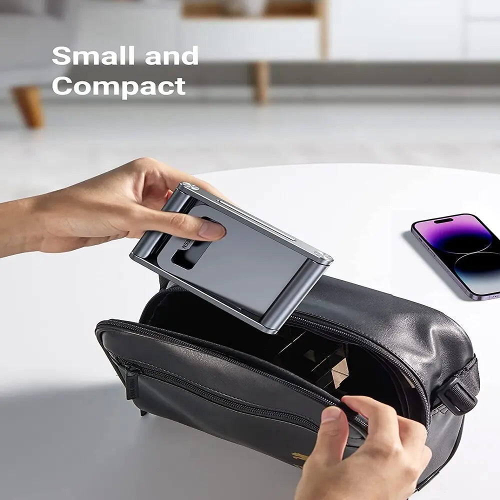 UGREEN LP263 compact foldable aluminium phone stand being placed inside a travel bag