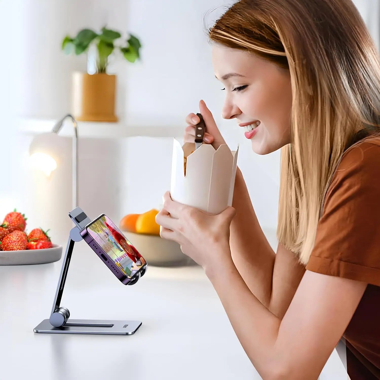 UGREEN LP678 adjustable smartphone stand used for hands-free recipe viewing in a kitchen