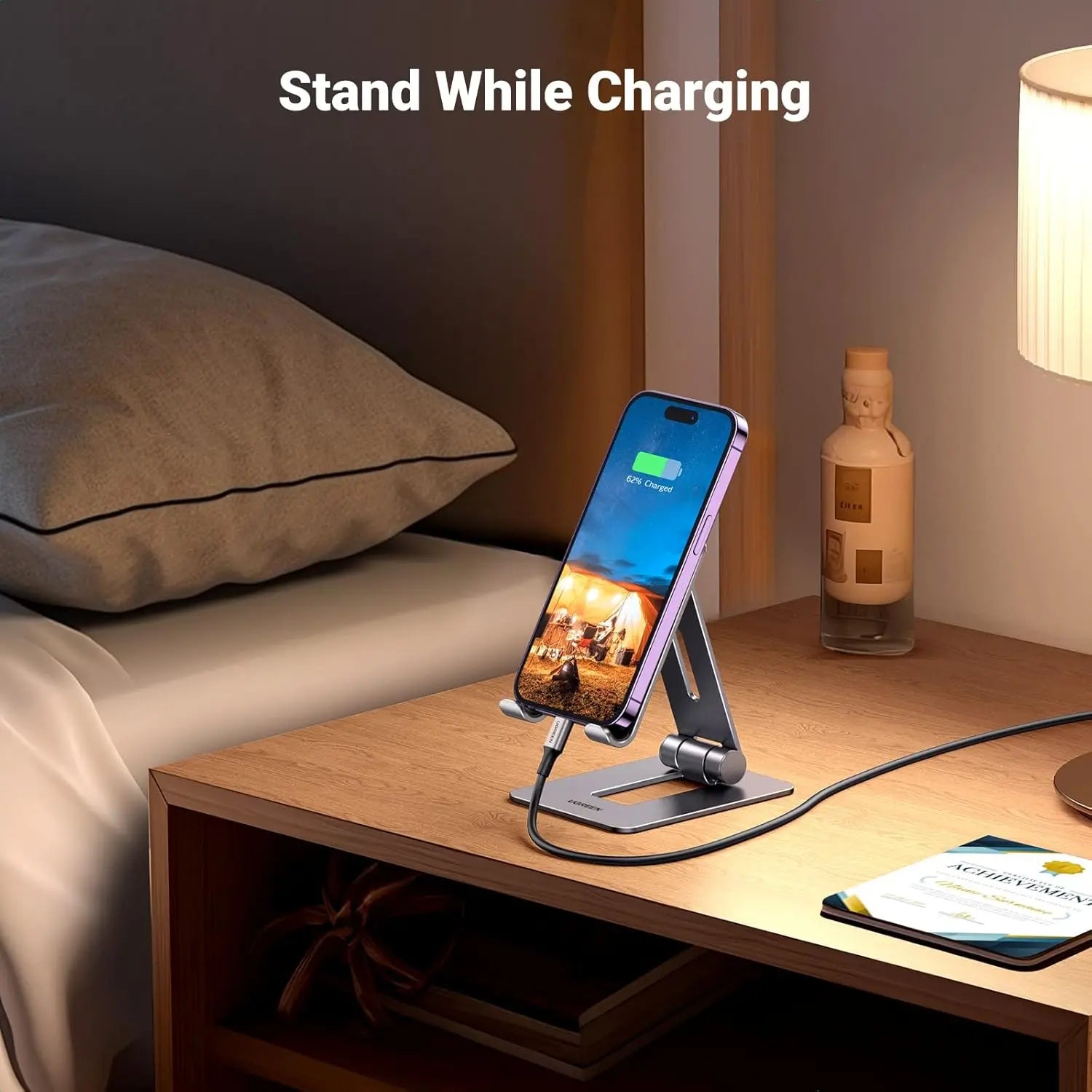 UGREEN LP678 phone stand providing charging-cable access on a bedside table