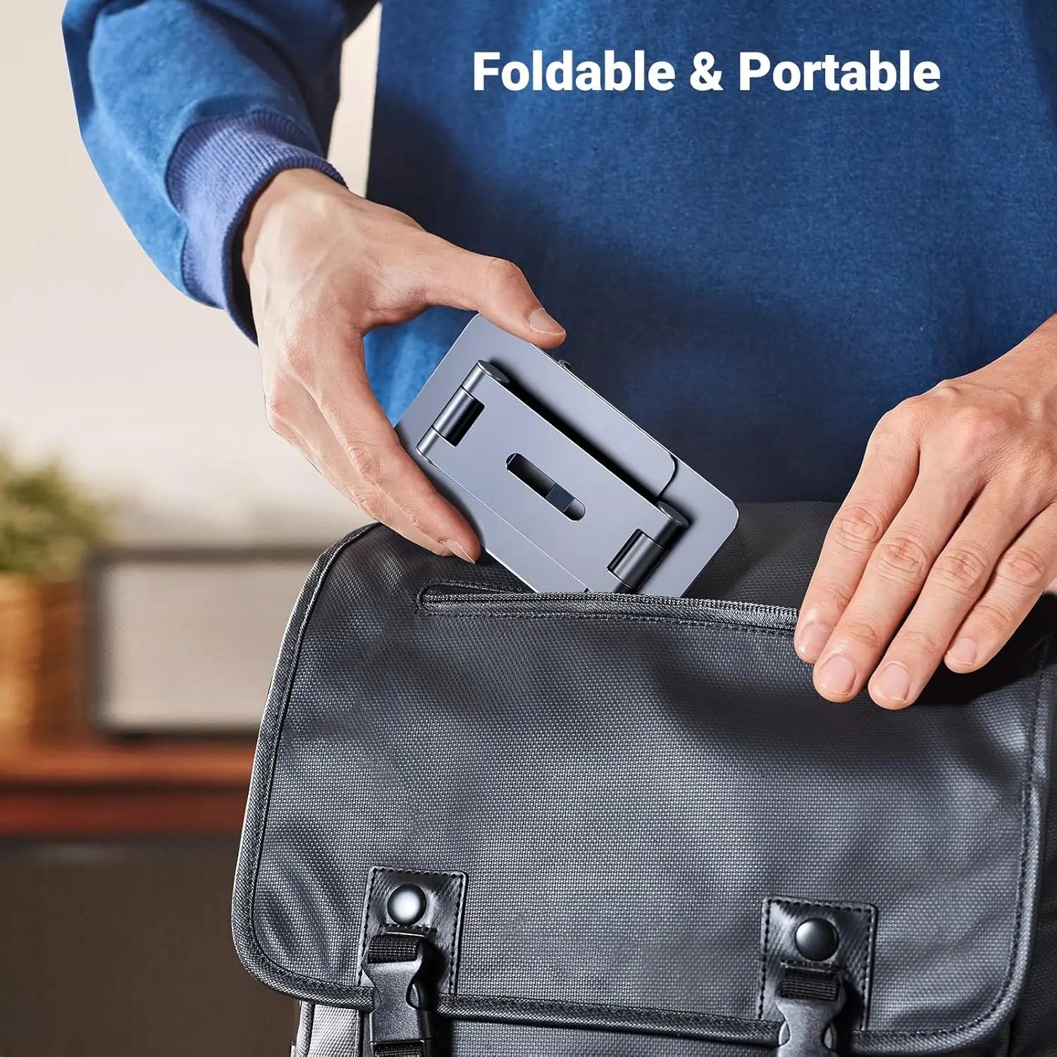 UGREEN LP678 compact foldable aluminium phone stand being placed inside a travel bag