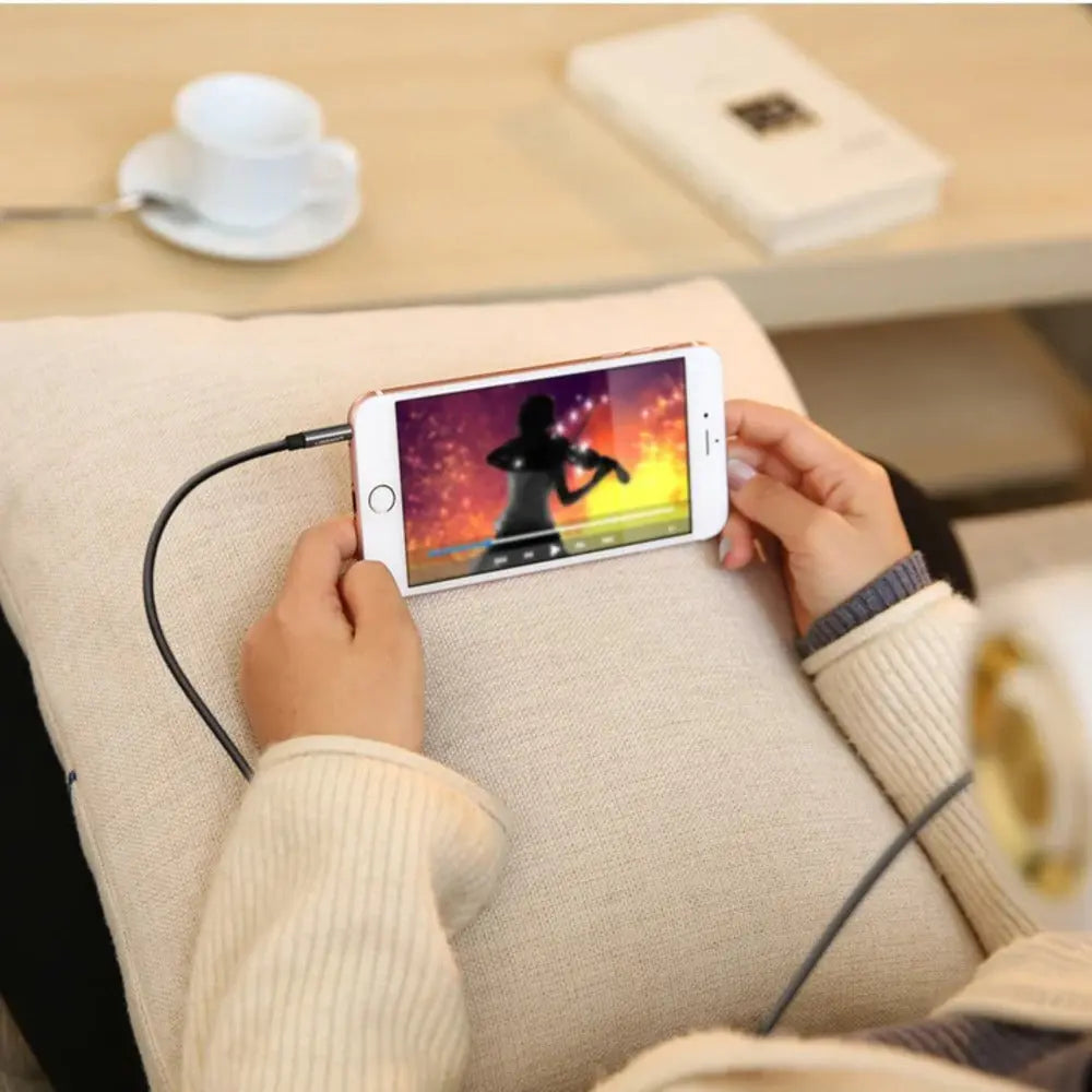 UGREEN 3.5mm AUX audio cable connected to phone for music playback