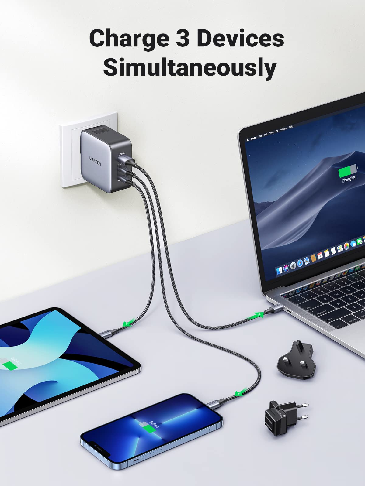 UGREEN 65W charger charging a laptop, tablet and phone at the same time